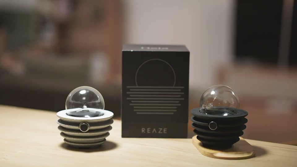 REAZE lamps and branded box on a wooden table in the original launch film